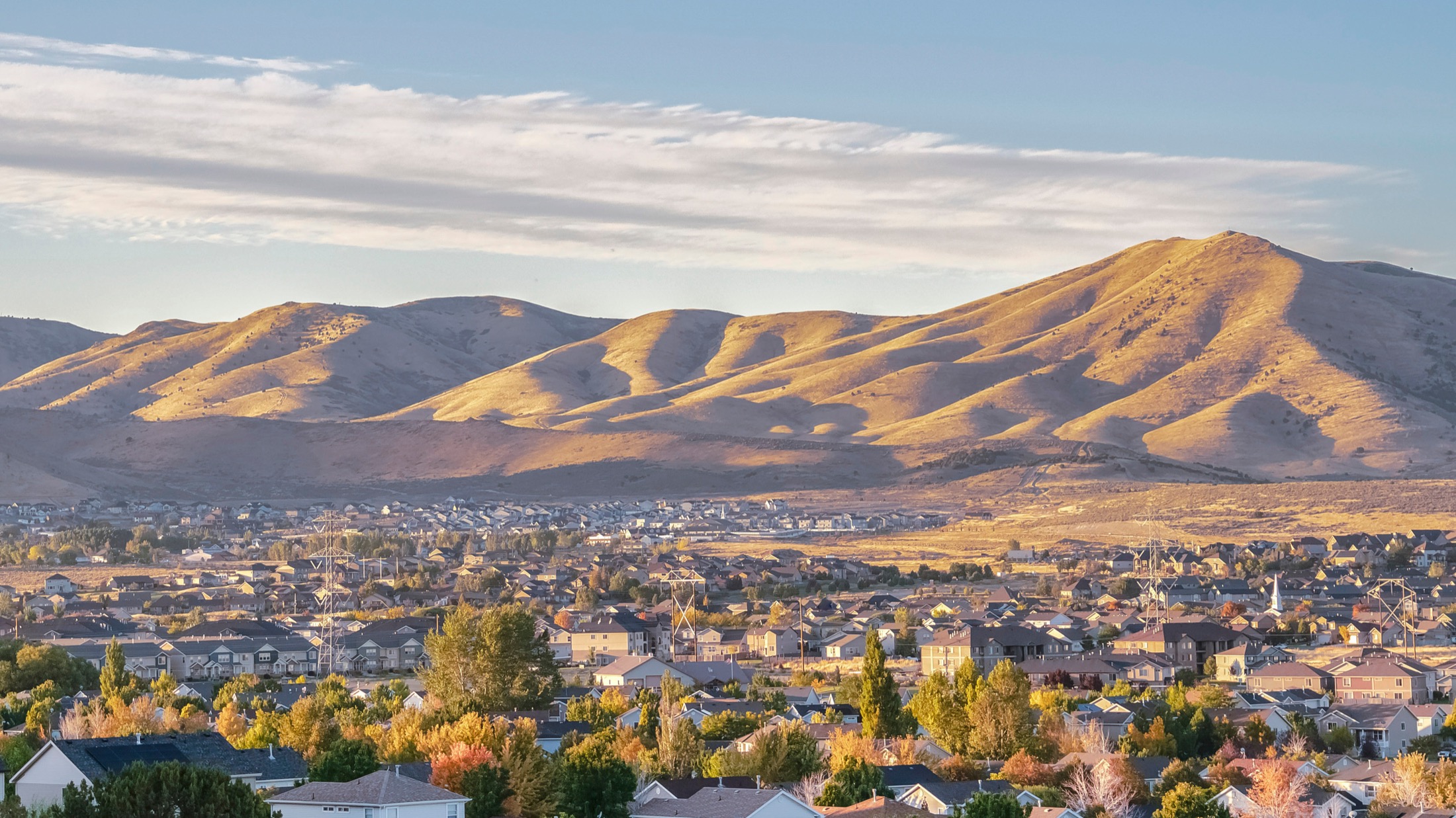 Homes across the Utah Valley at sunrise beneath the Wasatch